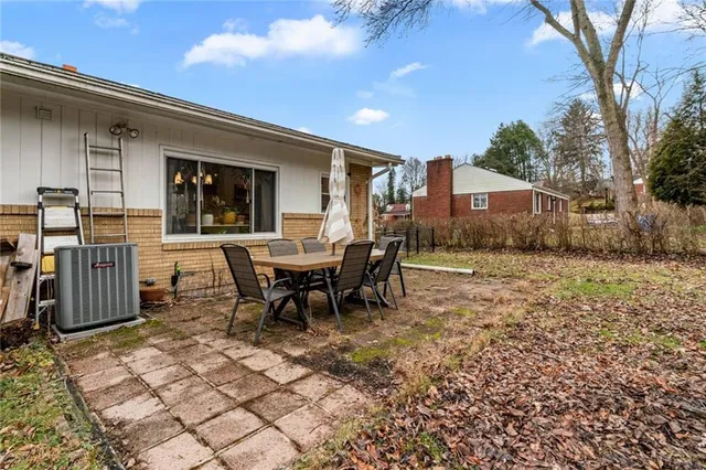 a view of a dinning table and chairs in the back yard