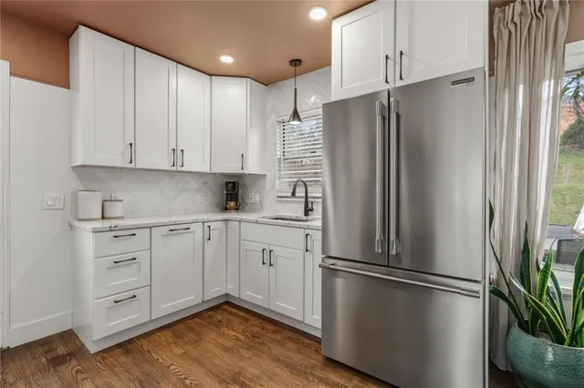 a kitchen with stainless steel appliances a refrigerator sink and cabinets