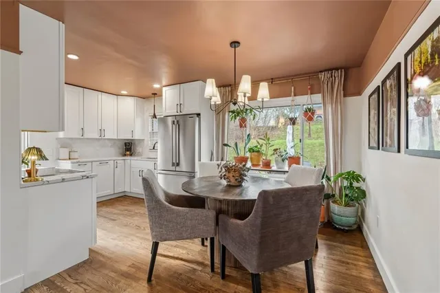 a kitchen with kitchen island a table and chairs in it