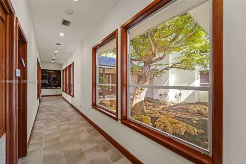 a bed room with a bed and a large window