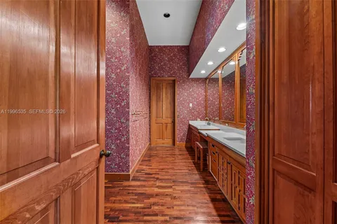 a spacious bathroom with a double vanity sink and a large mirror