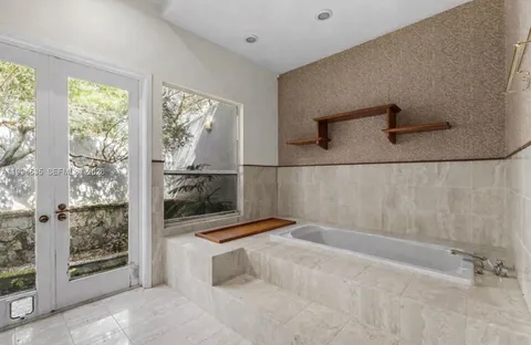 a living room with furniture a rug and white walls