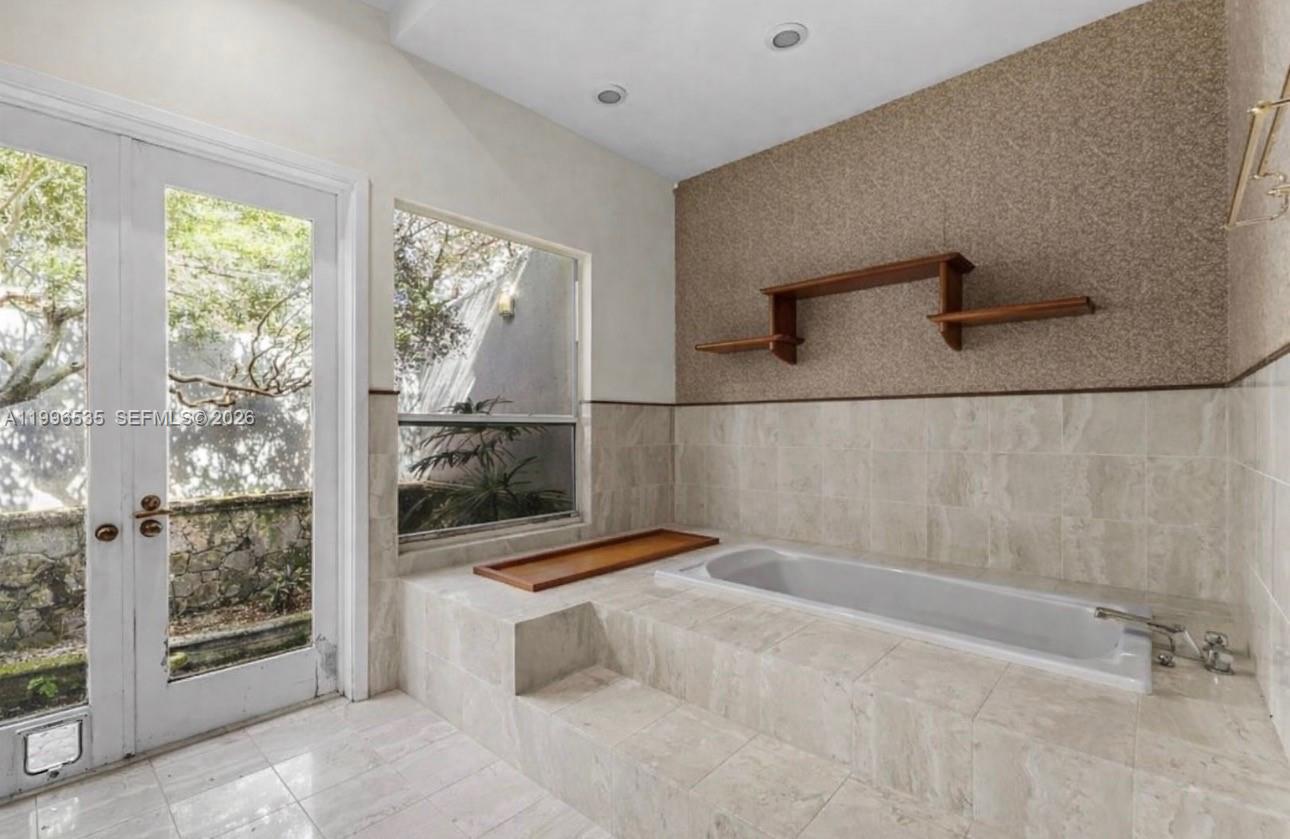 15001 Southwest 256th Street Homestead, FL 33032 - Photo 26 of 44 a bathroom with a bathtub and shower