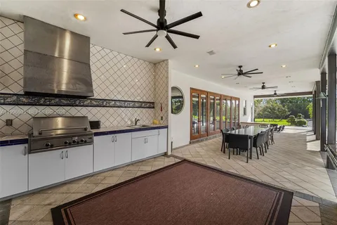 a view of a dining hall with lots of furniture and windows