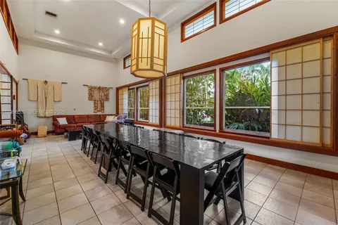 a living room with furniture and large windows