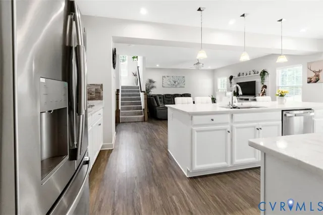 a kitchen with stainless steel appliances a refrigerator sink and cabinets