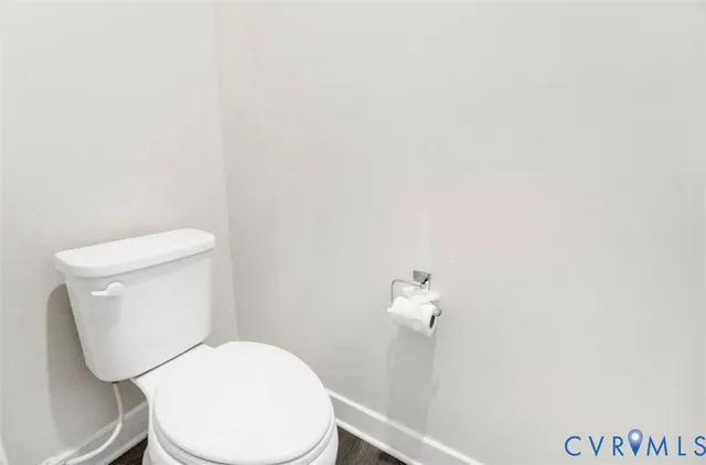 a white toilet sitting next to a shower
