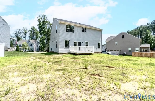 a view of a house with a yard and sitting area
