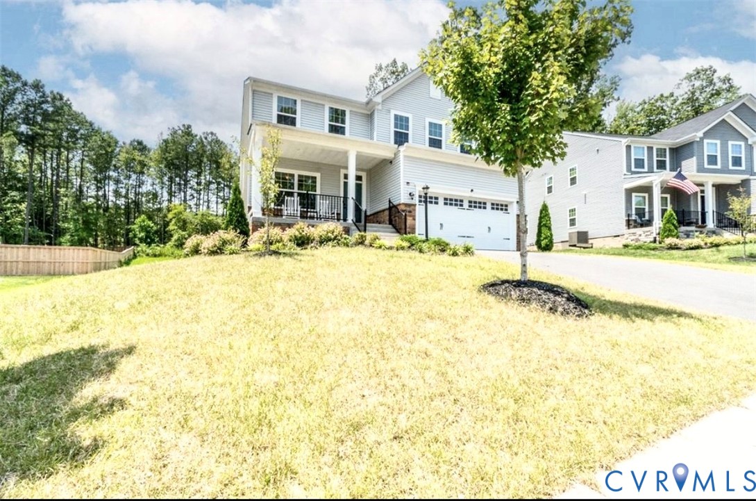 16043 Cambria Cove Boulevard Midlothian, VA 23112 - Photo 27 of 44 a front view of a house with a yard