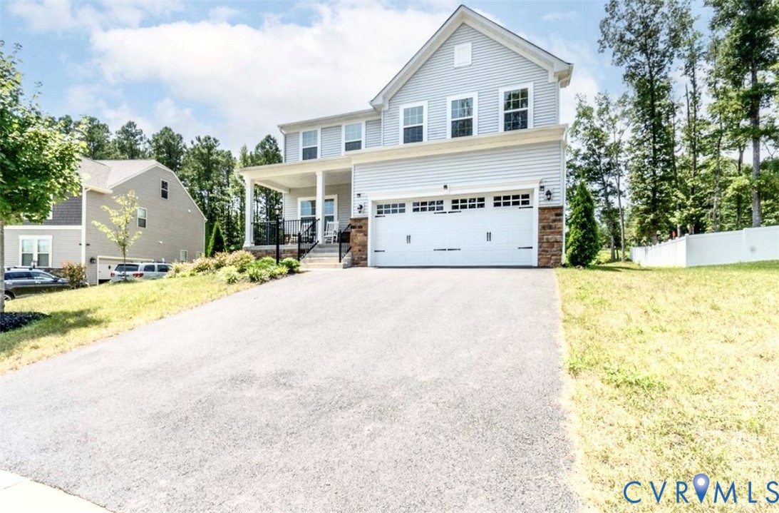 16043 Cambria Cove Boulevard Midlothian, VA 23112 - Photo 28 of 44 a view of a house with a patio and a yard