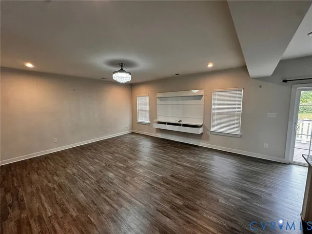 a kitchen with a sink a counter top space stainless steel appliances and wooden floor