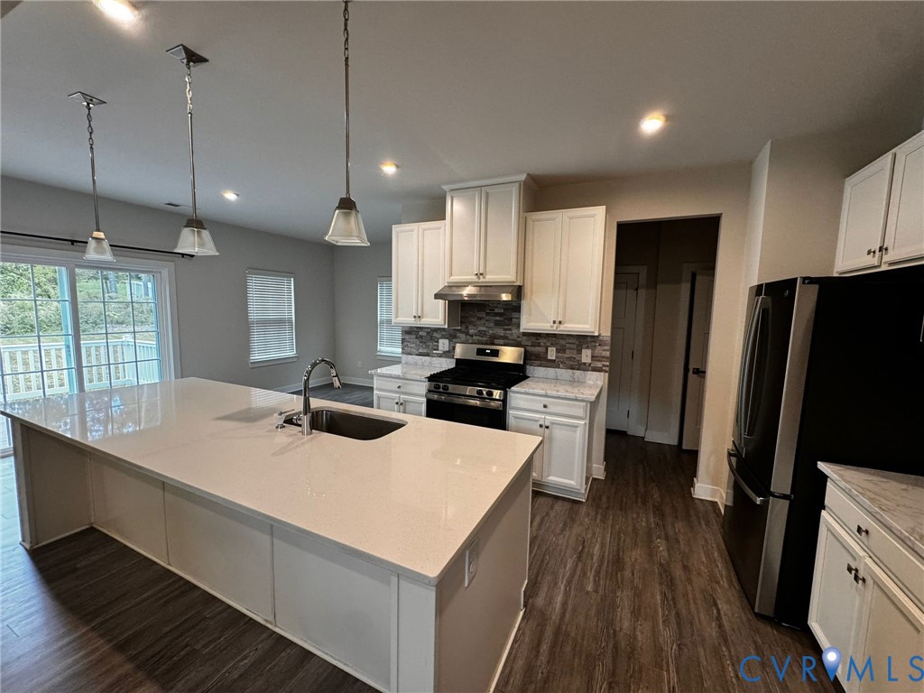 16043 Cambria Cove Boulevard Midlothian, VA 23112 - Photo 34 of 44 a kitchen with a sink a counter top space stainless steel appliances and wooden floor