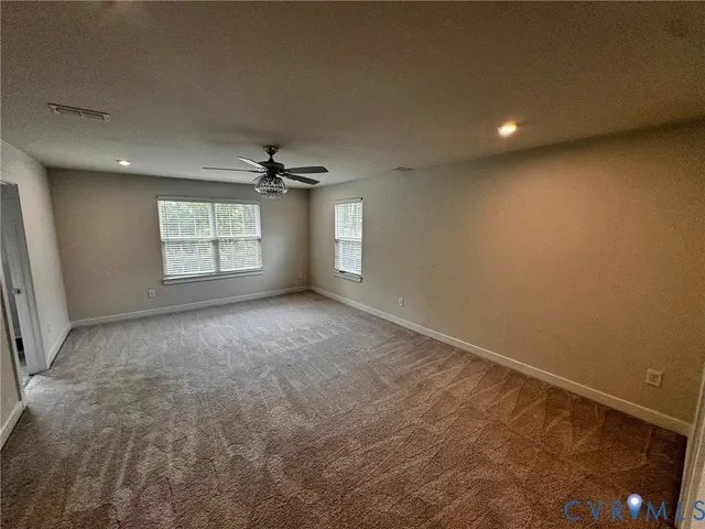 a large kitchen with kitchen island a stove a sink a refrigerator and a dining table with wooden floor