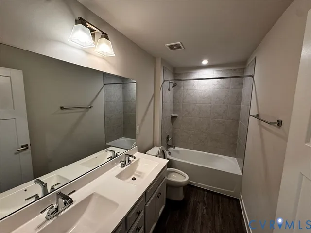 a bathroom with 2 sink tub and a mirror