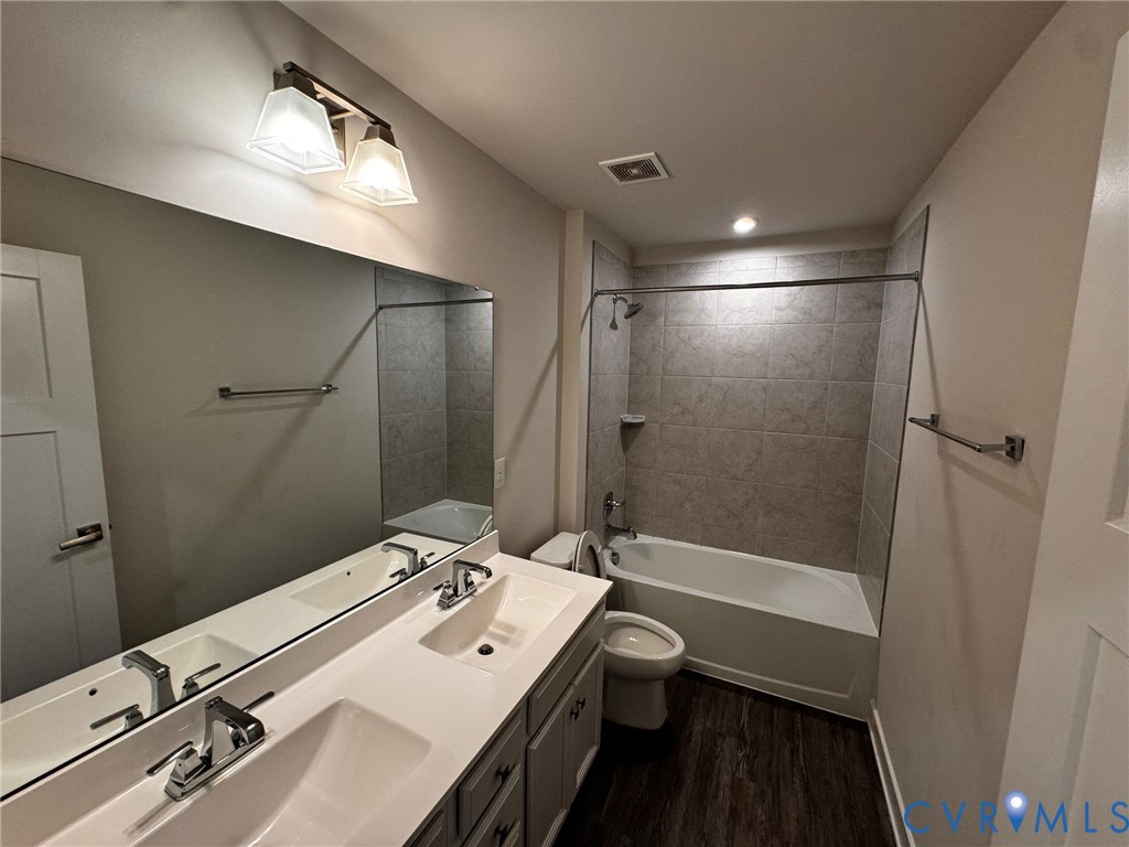 16043 Cambria Cove Boulevard Midlothian, VA 23112 - Photo 41 of 44 a bathroom with a sink a toilet a shower and a mirror