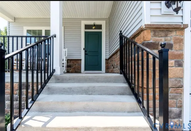 a view of staircase with railing and lots of frames on wall