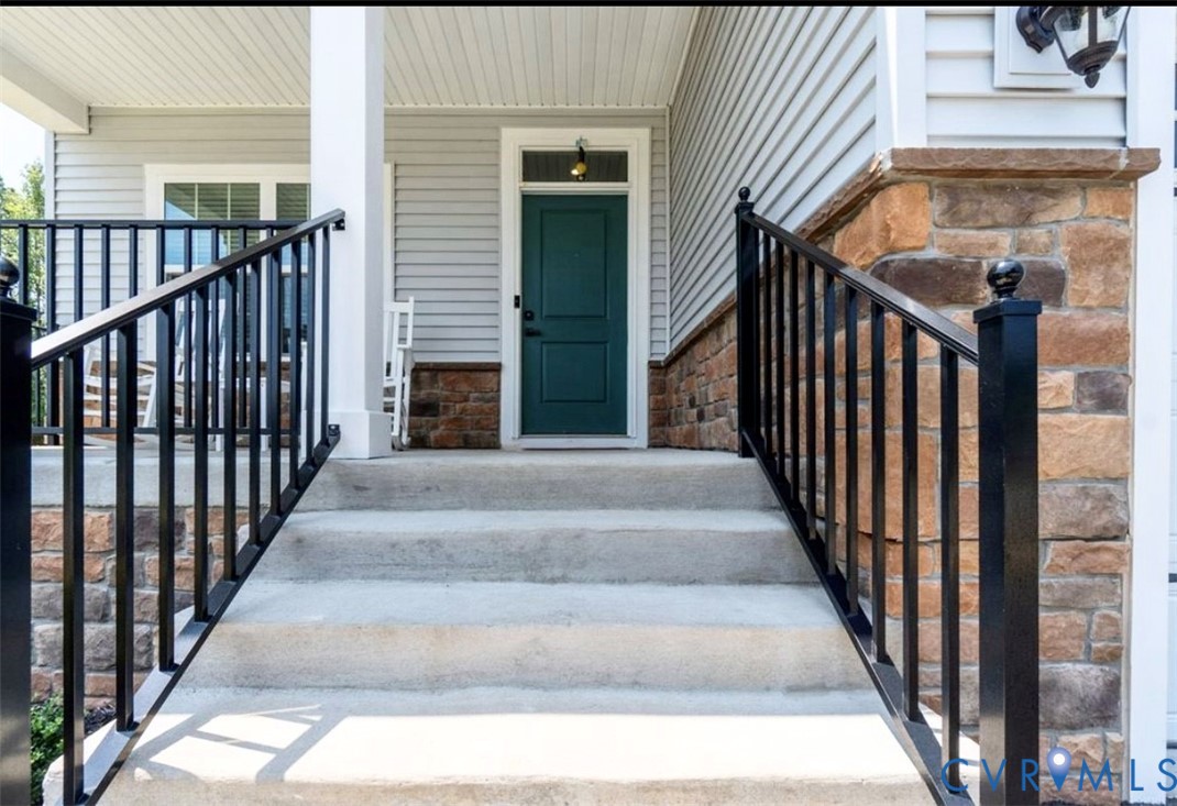16043 Cambria Cove Boulevard Midlothian, VA 23112 - Photo 5 of 44 a view of staircase with railing and lots of frames on wall