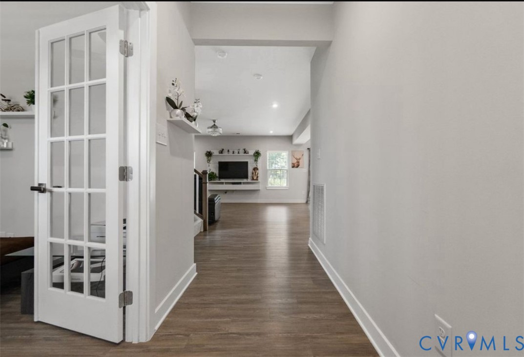 16043 Cambria Cove Boulevard Midlothian, VA 23112 - Photo 7 of 44 a view of a hallway with wooden floor and staircase