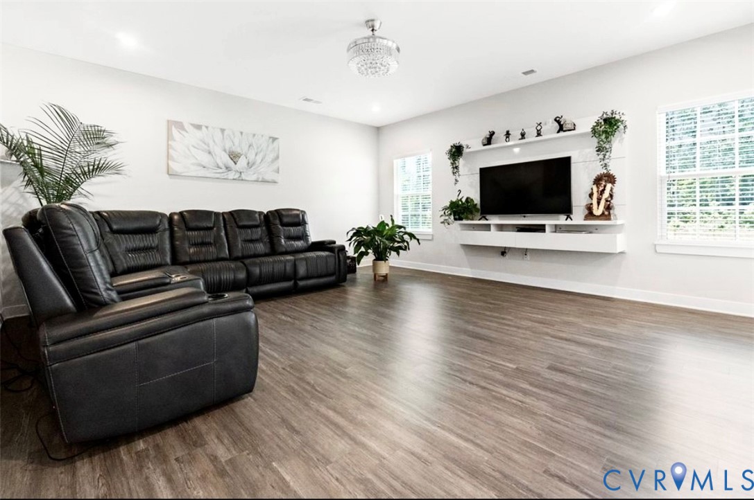 16043 Cambria Cove Boulevard Midlothian, VA 23112 - Photo 8 of 44 a living room with furniture and a flat screen tv
