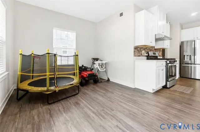 a room with wooden floor and a sink