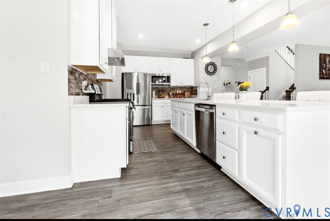 16043 Cambria Cove Boulevard Midlothian, VA 23112 - Photo 10 of 44 a kitchen with cabinets and wooden floor