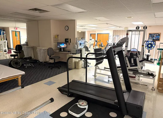 a living room with furniture a air conditioner and a window