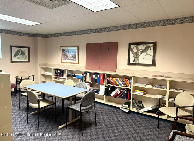 a living room with furniture a flat screen tv and a window