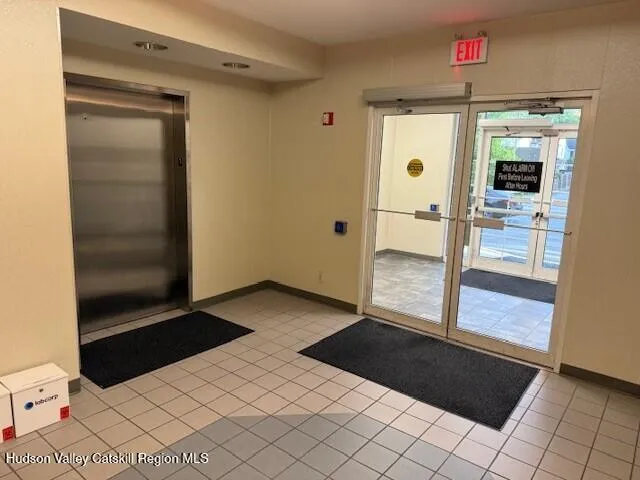 a view of a workspace with furniture and a window