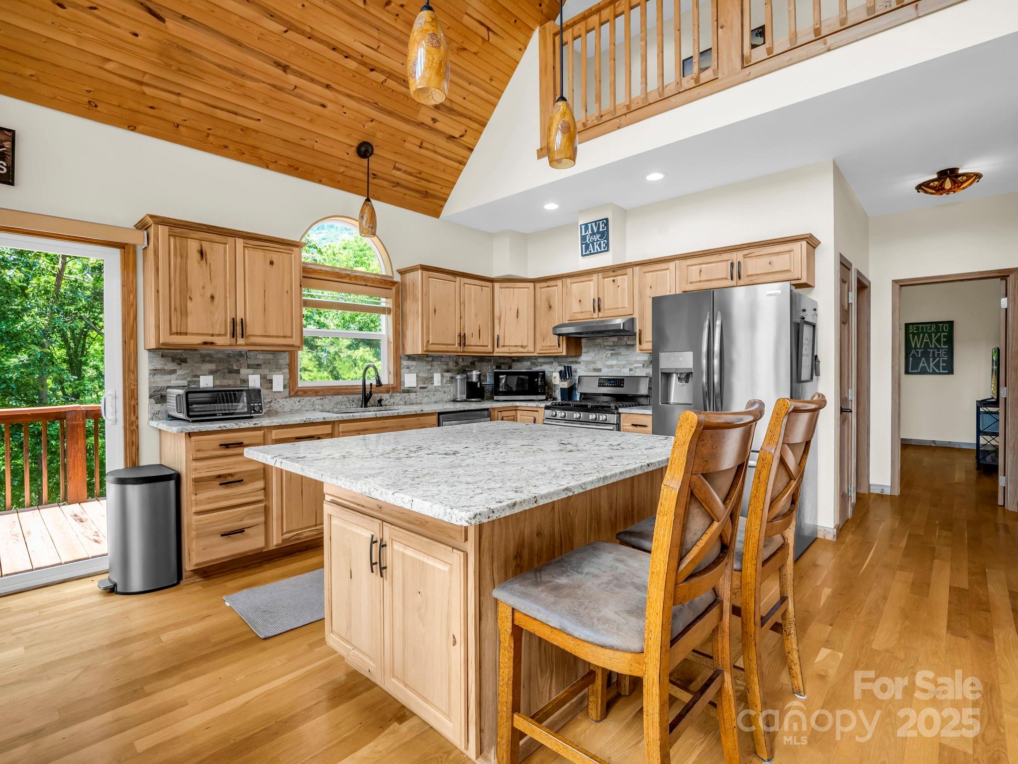188 Fern Loop Lake Lure, NC 28746 - Photo 15 of 48 a kitchen with stainless steel appliances granite countertop a stove a sink and a refrigerator
