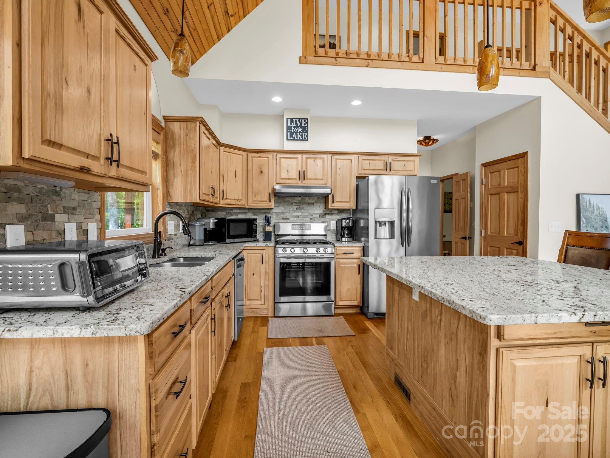 188 Fern Loop Lake Lure, NC 28746 - Photo 17 of 48 a kitchen with stainless steel appliances granite countertop a stove a sink and a refrigerator