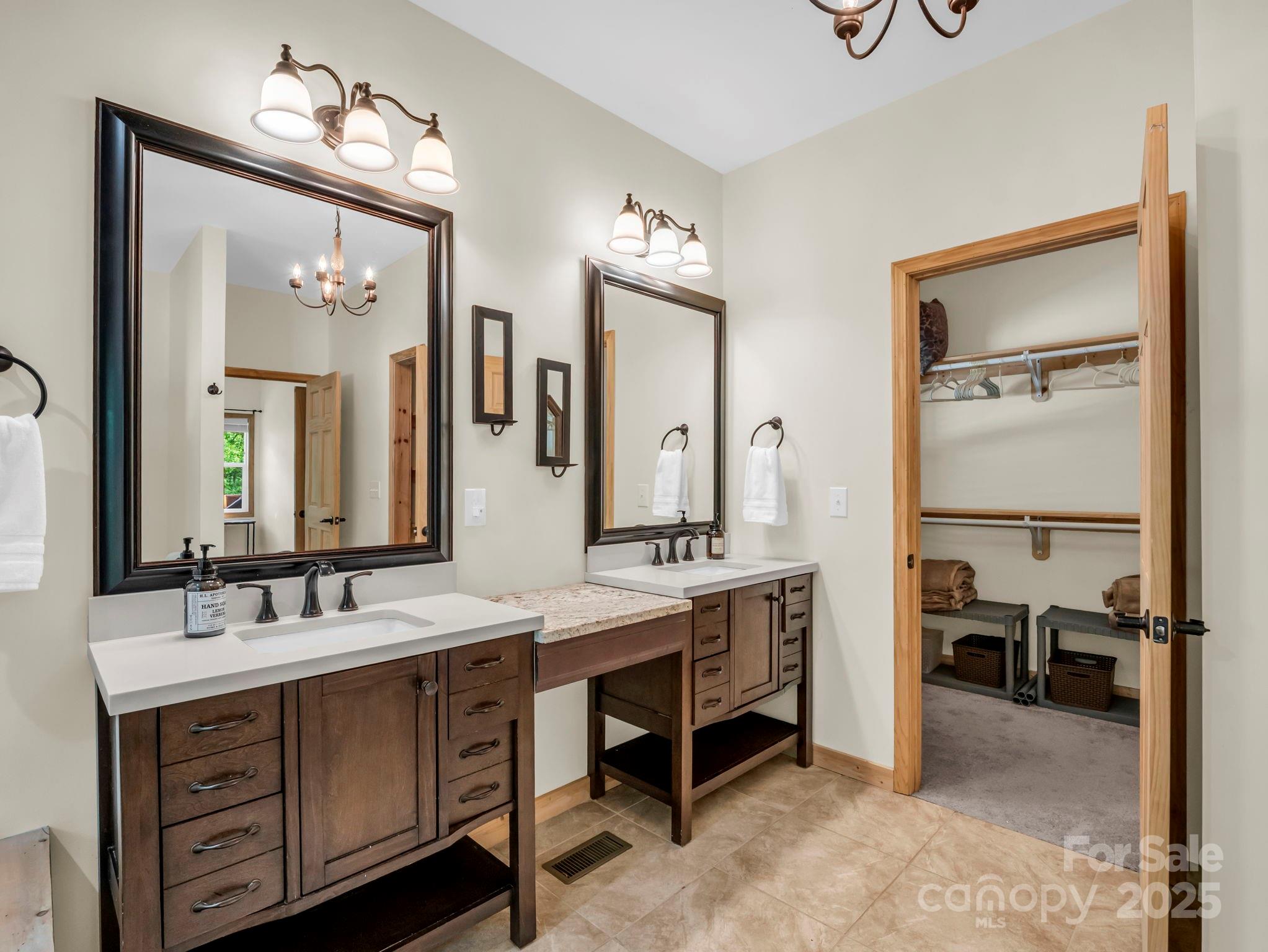 188 Fern Loop Lake Lure, NC 28746 - Photo 24 of 48 a spacious bathroom with a double vanity sink and a mirror