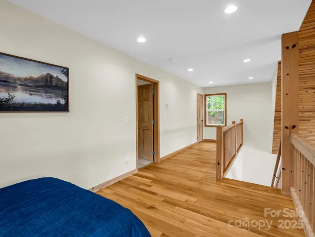a view of a livingroom with wooden floor and furniture