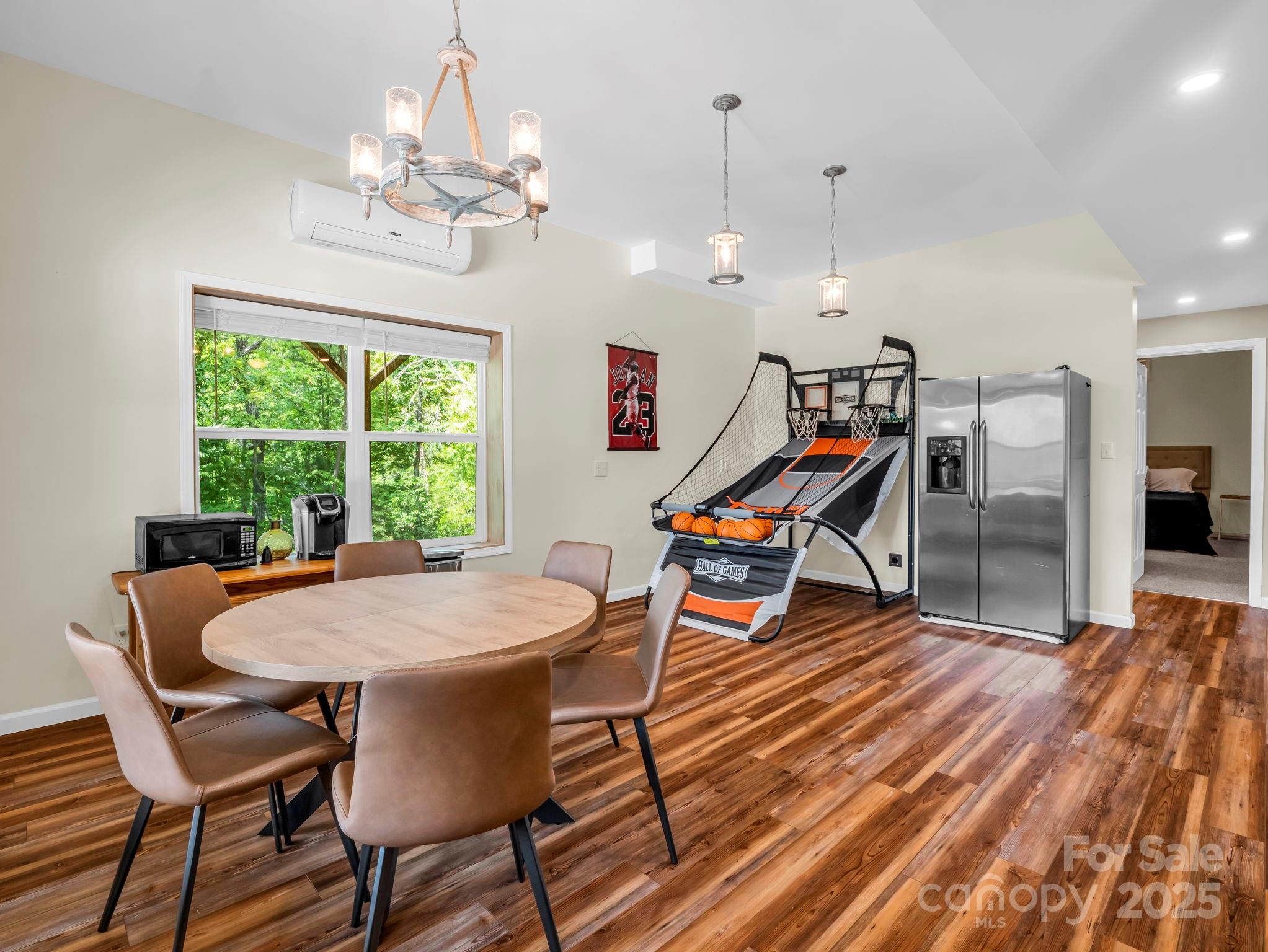 188 Fern Loop Lake Lure, NC 28746 - Photo 35 of 48 a dining room with furniture a chandelier and wooden floor