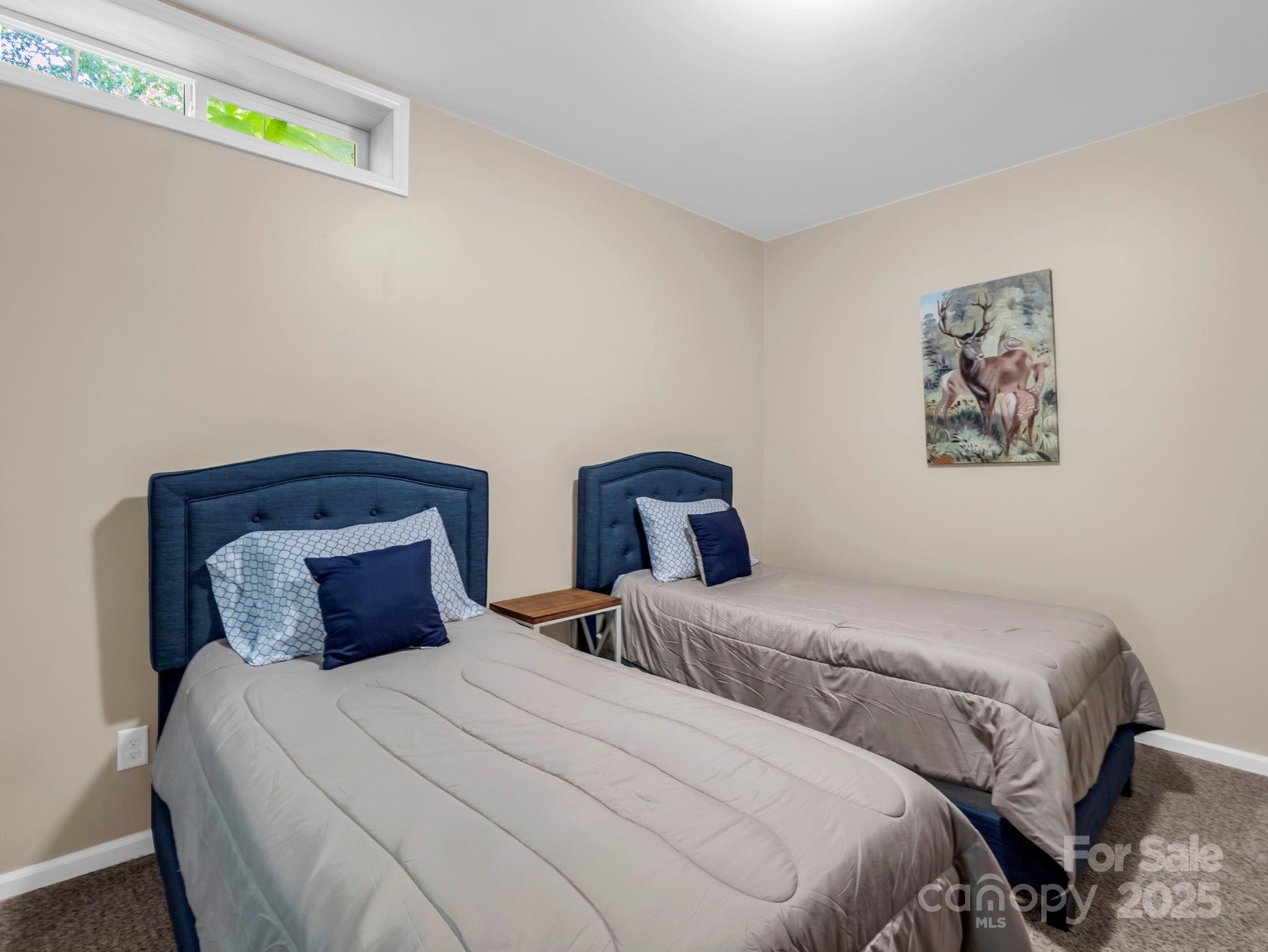 188 Fern Loop Lake Lure, NC 28746 - Photo 41 of 48 a bedroom with bed and painting on the wall