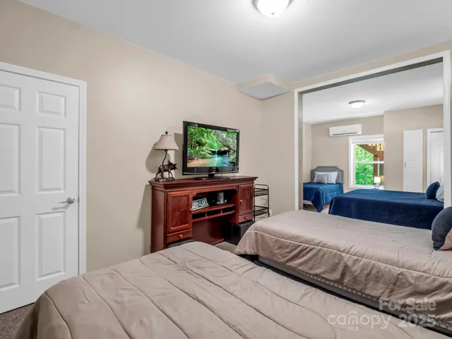 a bedroom with a bed and a flat screen tv
