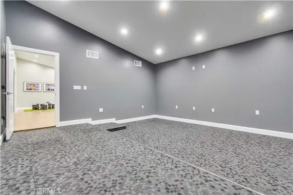 an empty room with a projector and screen