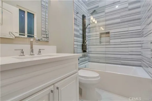 a bathroom with a sink a toilet and bathtub