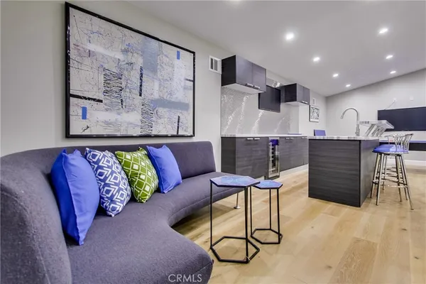 a living room with furniture and kitchen view