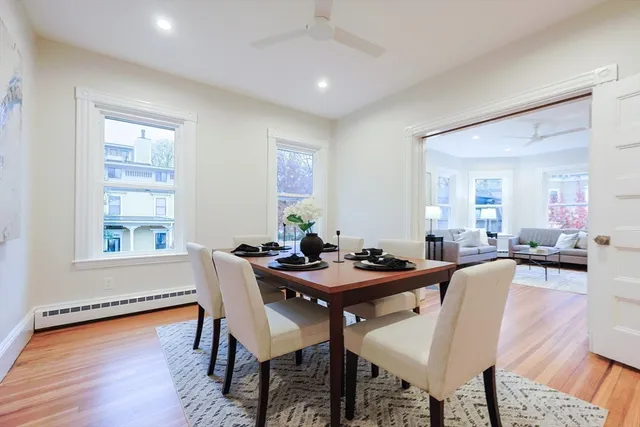 a dining room with furniture and wooden floor