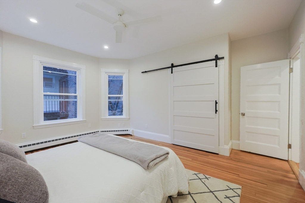 28 Inman Street, Unit 4 Cambridge, MA 02139 - Photo 17 of 32 a bedroom with a bed and a window