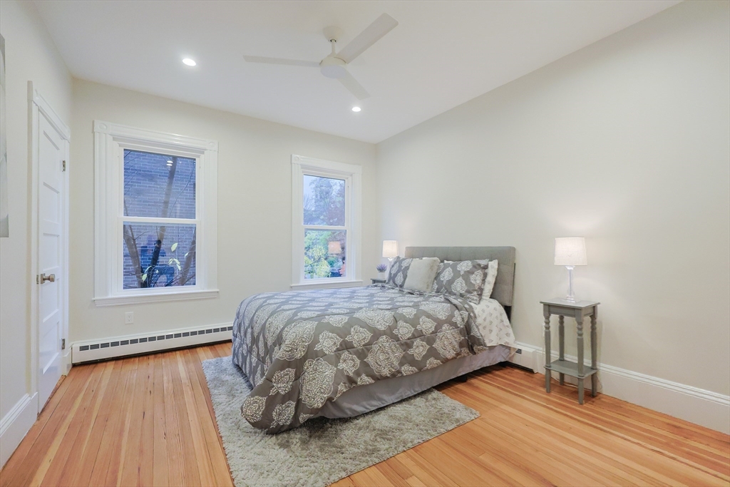 28 Inman Street, Unit 4 Cambridge, MA 02139 - Photo 21 of 32 a bedroom with a bed and a wooden floor