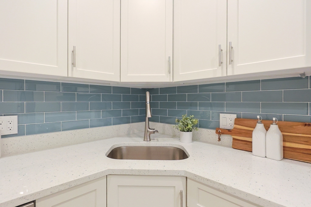 28 Inman Street, Unit 4 Cambridge, MA 02139 - Photo 10 of 32 a bathroom with a sink and a white wooden cabinets