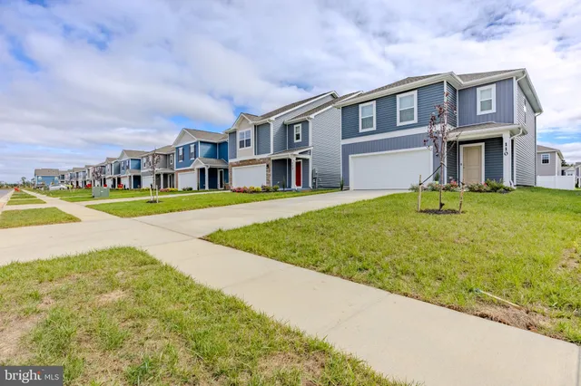 a view of an apartment with a swimming pool and a yard