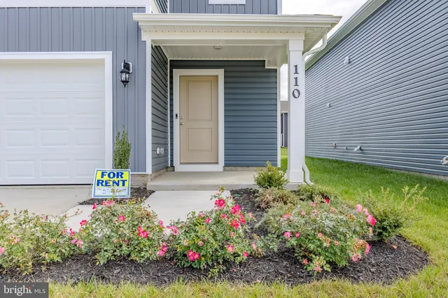 a front view of house with flowers