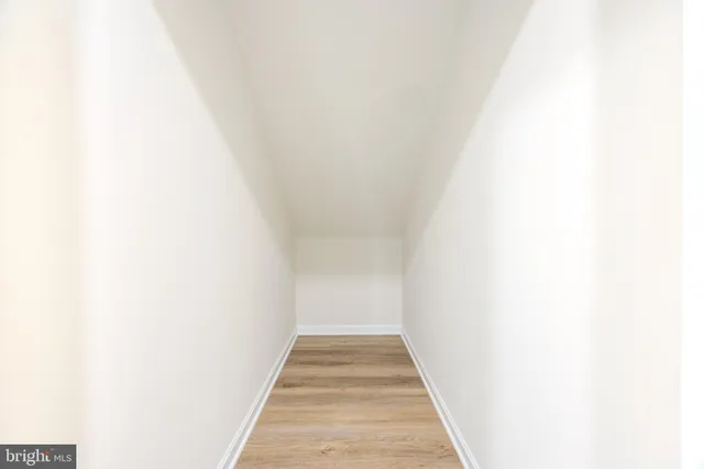 a view of a hallway with white walls