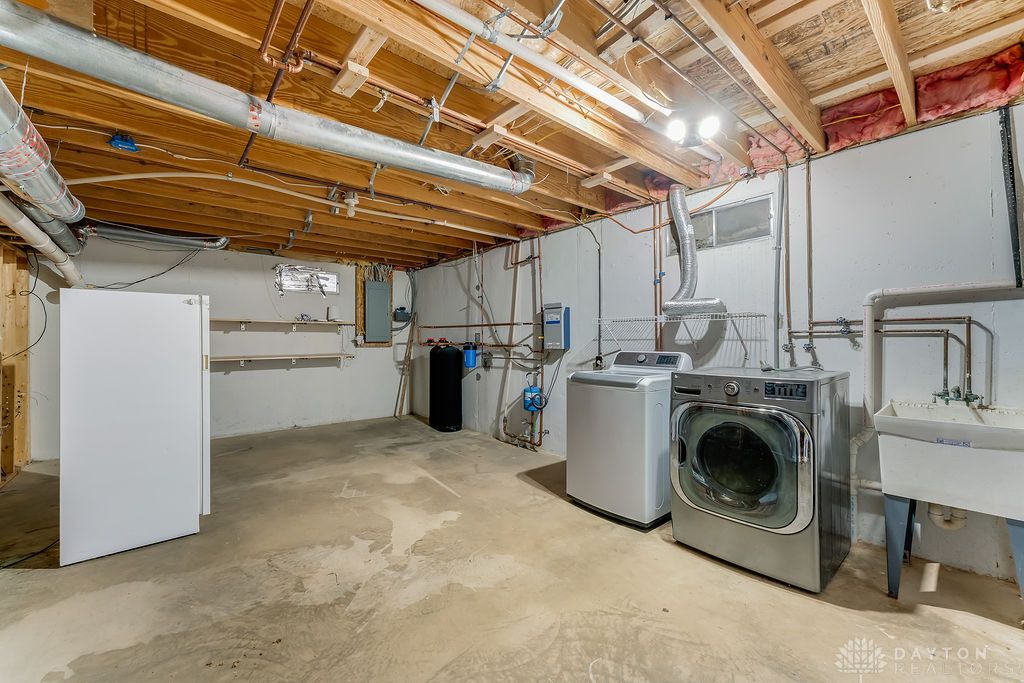 7400 Cook-Jones Road Waynesville, OH 45068 - Photo 54 of 72 This spacious utility area offers ample room for laundry tasks and additional storage.