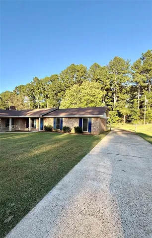 a view of a big house with a big yard