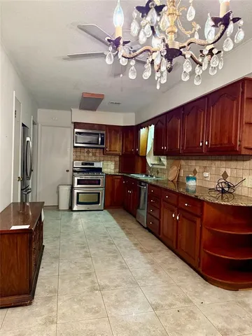 a kitchen with cabinets and appliances