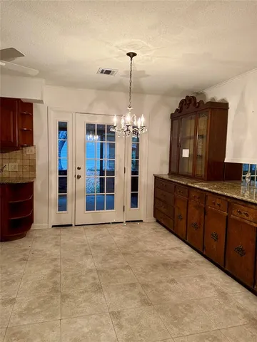 a view of an empty room with a kitchen