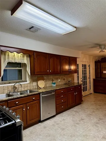 a kitchen with a sink stove and cabinets
